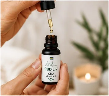 Hand håller CBD Olja 10% Välmående med pipett utdragen